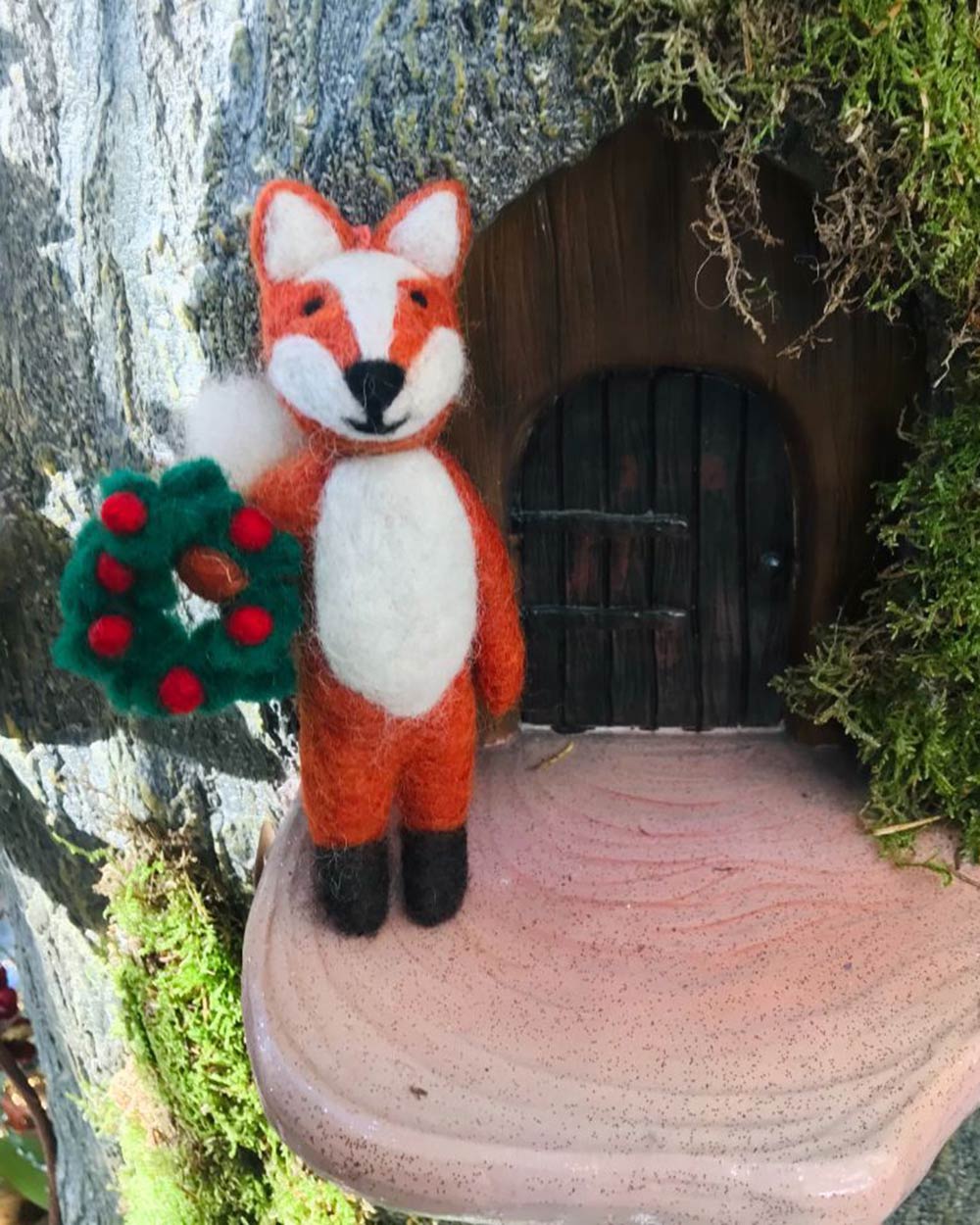 This adorable felt fox will definitely put a smile on your face. So, put on those Christmas songs, and happily decorate your tree! Made from 100% Wool with no plastic or glue in sight! This little character is charming in every single way. Designed with a red berry Christmas wreath in hand, this fox is delightful.