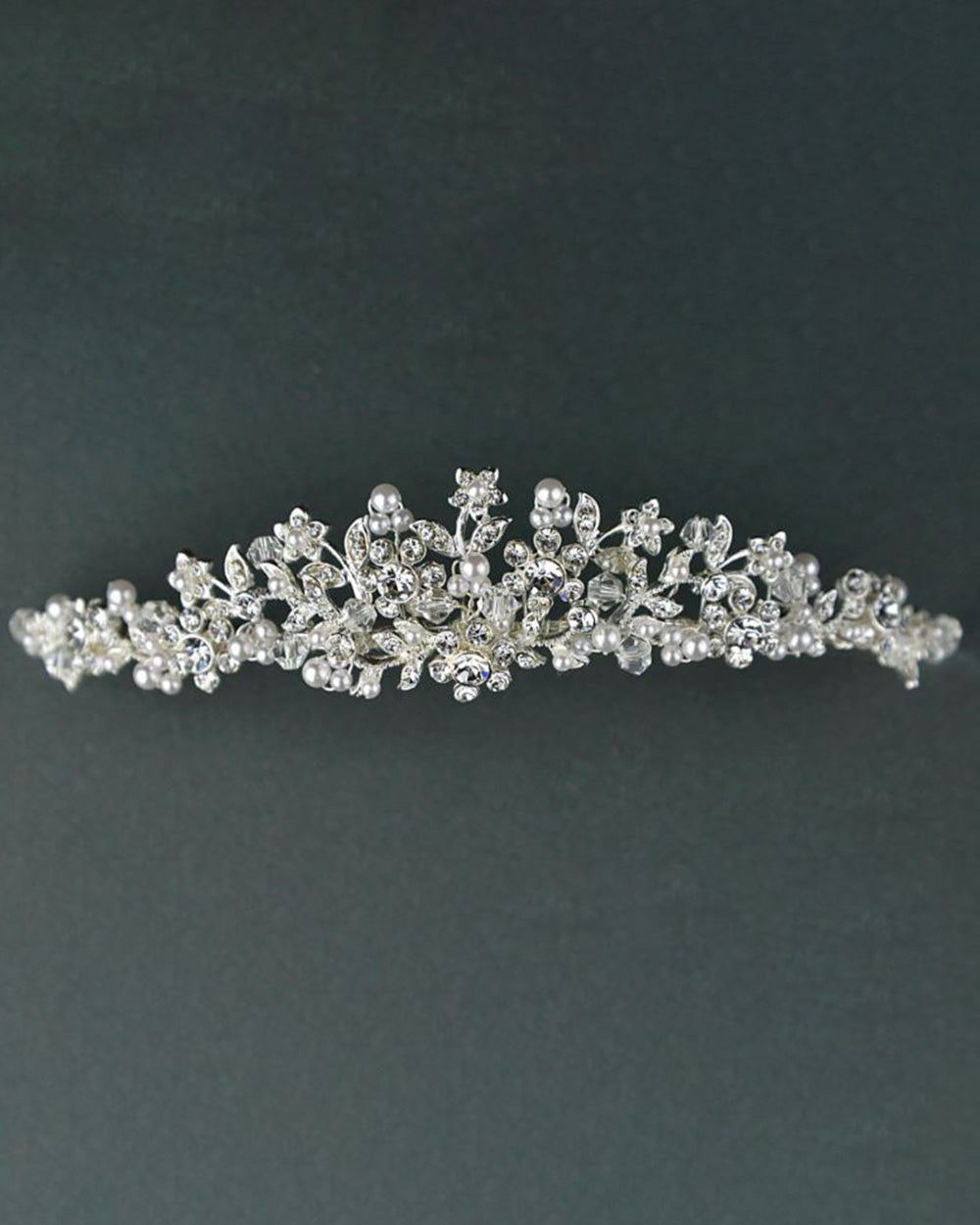 This diamante wedding tiara oozes sophistication and effortless style. Highly detailed with crystals and diamantes to create floral and leaf shapes. Decorated with stunning pearl beads for a classy and timeless design. Why not take advantage of any and all chances to wear a tiara. If you can't wear one on your wedding day, when can you? Every bride deserves to feel like a true princess on their big day. So, complete your bridal look with one of our beautiful wedding tiaras.