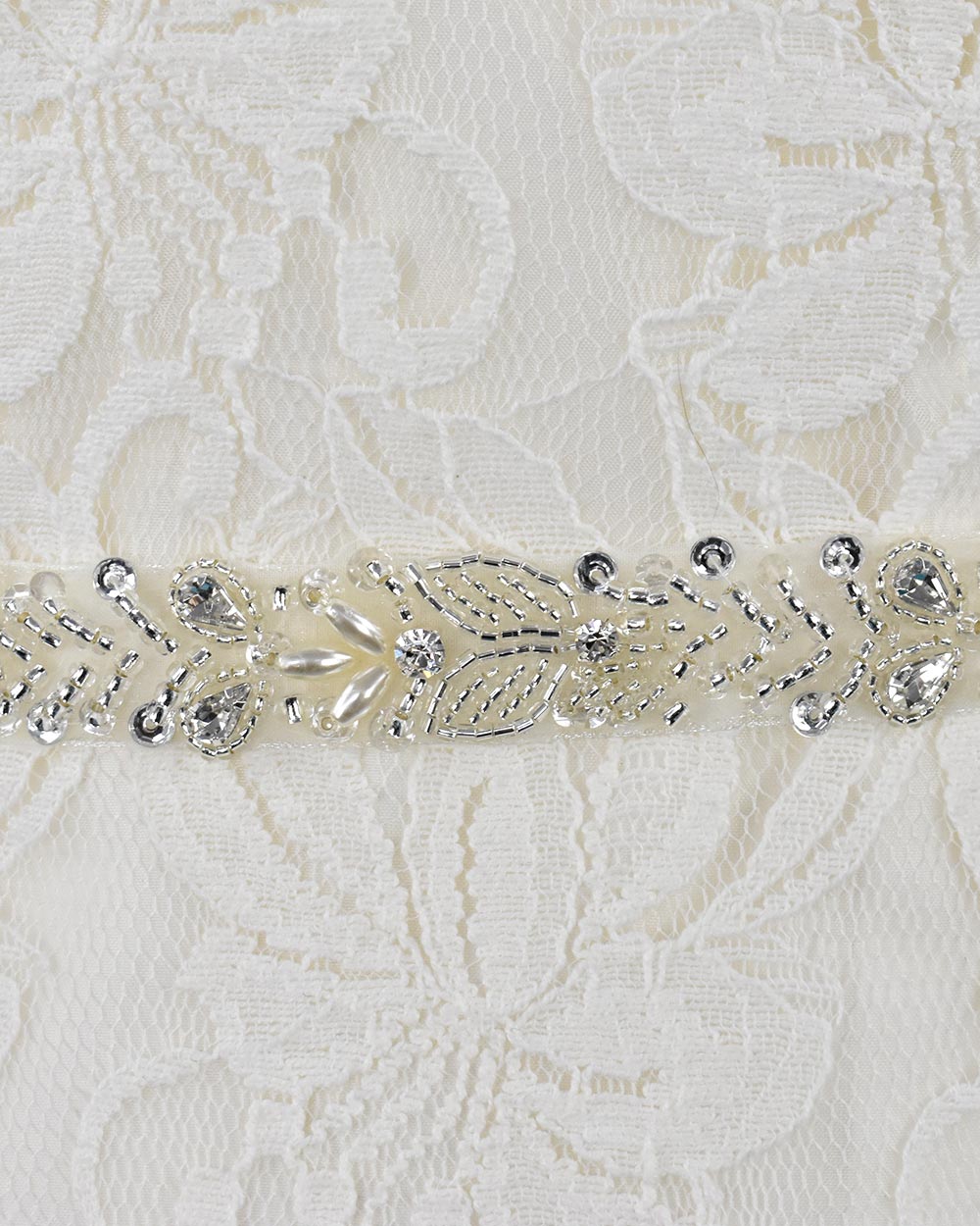 This beautiful wedding belt has a stunning leaf beaded design. With pearls and diamantes adding extra glamour to any wedding dress. Displayed on an 81" ivory organza ribbon, simply tie around your waist.
