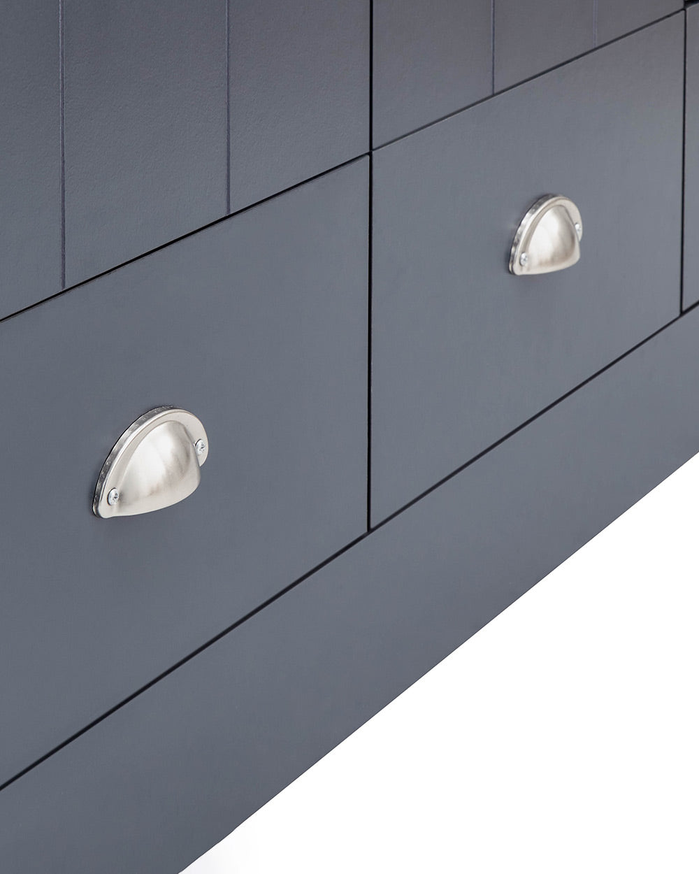 A 3 door wardrobe in modern slate blue offers ample storage space and elegant brushed steel handles. The wardrobe opens to reveal hanging space and a convenient shelf. It also features three drawers with cup handles. The bold slate blue colour complements any interior style and contrasts with the oak-effect top. The wardrobe is aesthetically pleasing and sturdy, with a deep base plinth. It comes flat packed for self-assembly. Delivery is available only to mainland UK, excluding certain postcodes.