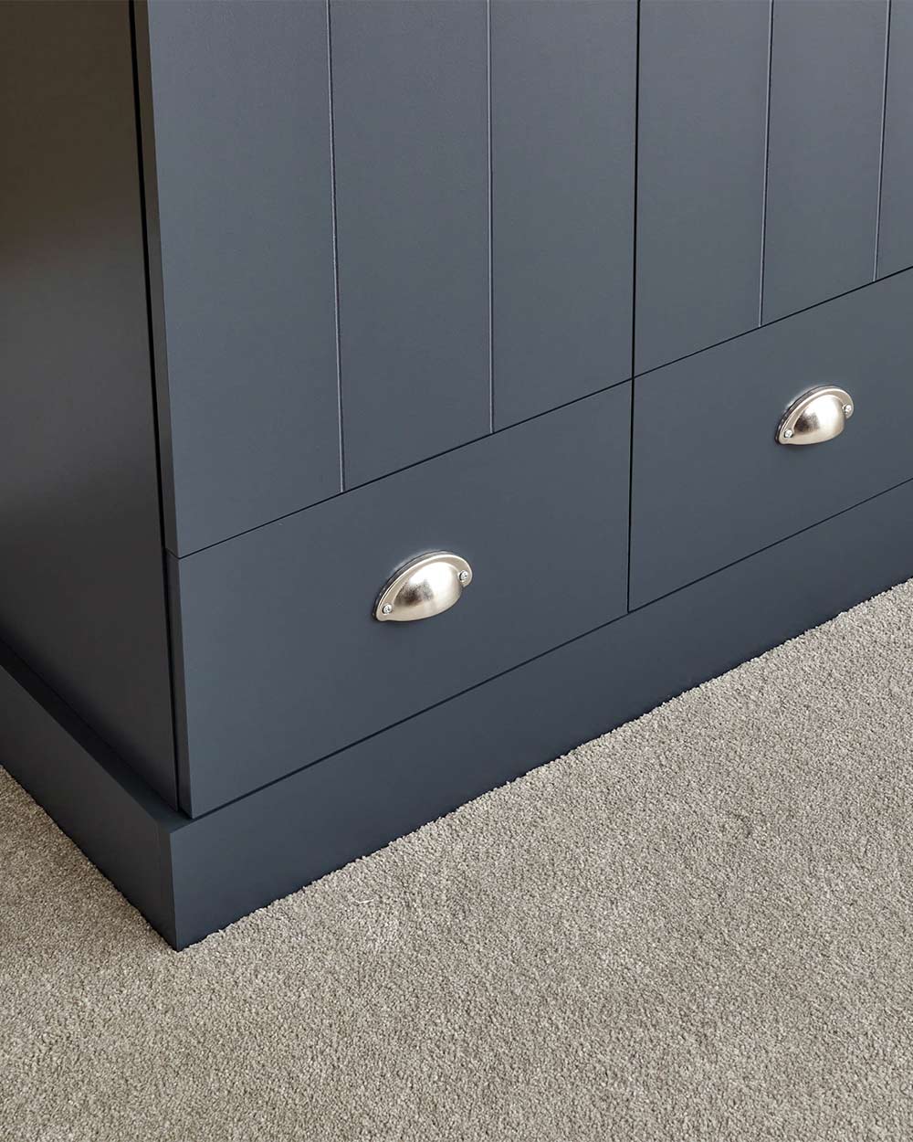 A 3 door wardrobe in modern slate blue offers ample storage space and elegant brushed steel handles. The wardrobe opens to reveal hanging space and a convenient shelf. It also features three drawers with cup handles. The bold slate blue colour complements any interior style and contrasts with the oak-effect top. The wardrobe is aesthetically pleasing and sturdy, with a deep base plinth. It comes flat packed for self-assembly. Delivery is available only to mainland UK, excluding certain postcodes.