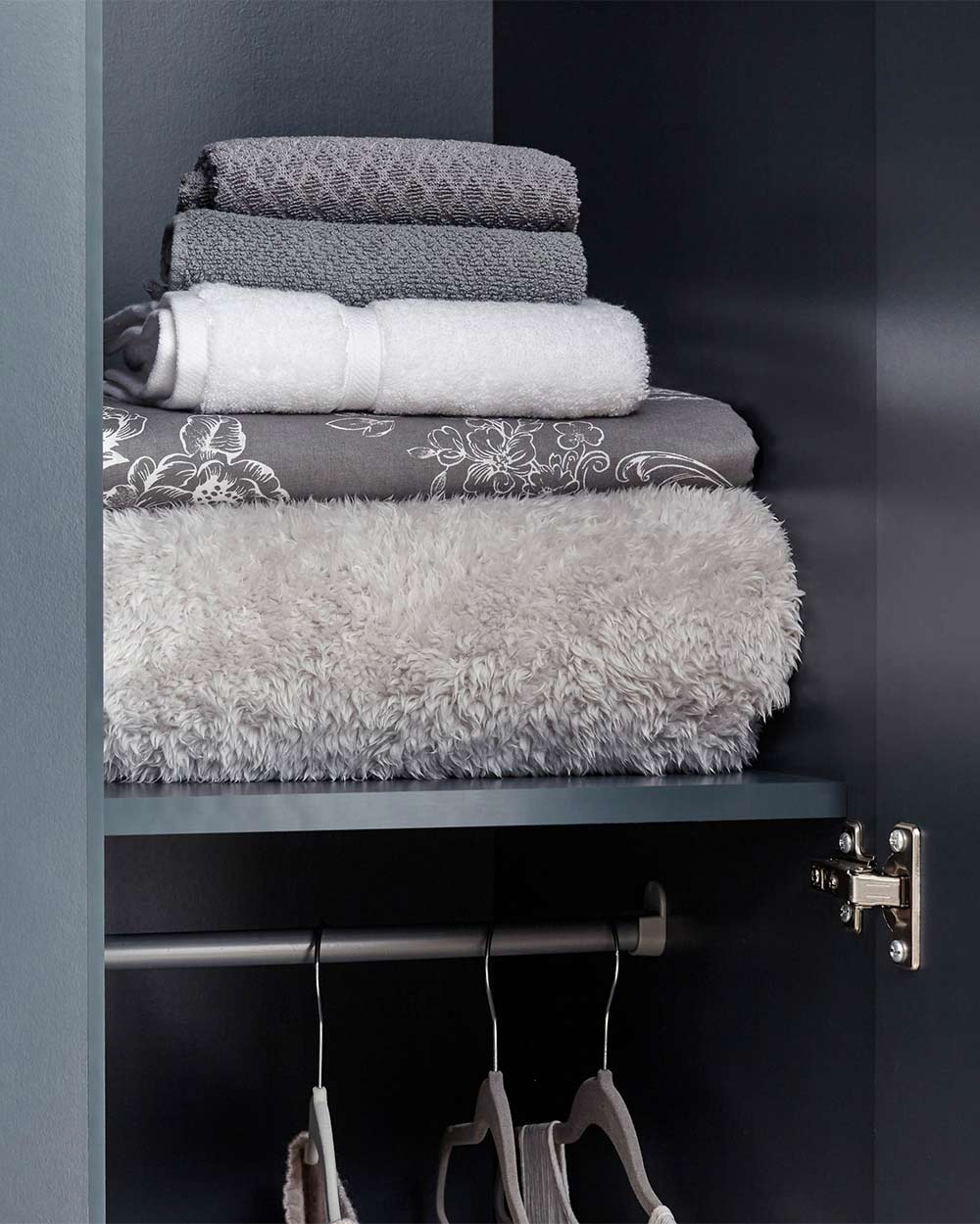 A 3 door wardrobe in modern slate blue offers ample storage space and elegant brushed steel handles. The wardrobe opens to reveal hanging space and a convenient shelf. It also features three drawers with cup handles. The bold slate blue colour complements any interior style and contrasts with the oak-effect top. The wardrobe is aesthetically pleasing and sturdy, with a deep base plinth. It comes flat packed for self-assembly. Delivery is available only to mainland UK, excluding certain postcodes.
