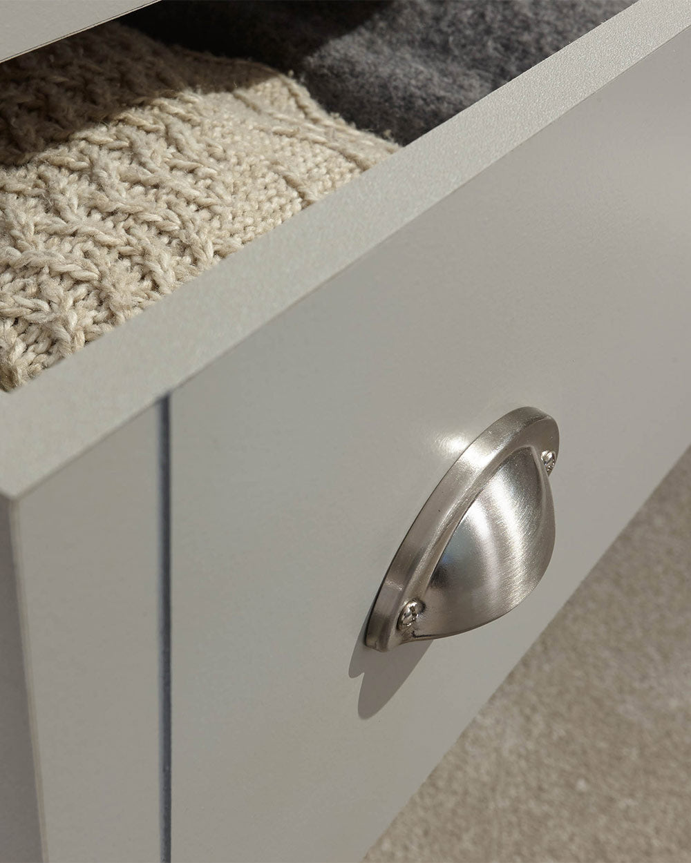 A modern grey chest of drawers with 3 drawers. Generous storage space for clothes and accessories. Features brushed steel cup handles and easy glide metal runners. Sturdy structure with a bevelled oak-effect top. Flat packed for home assembly. Perfect for adding a personal touch to your room.