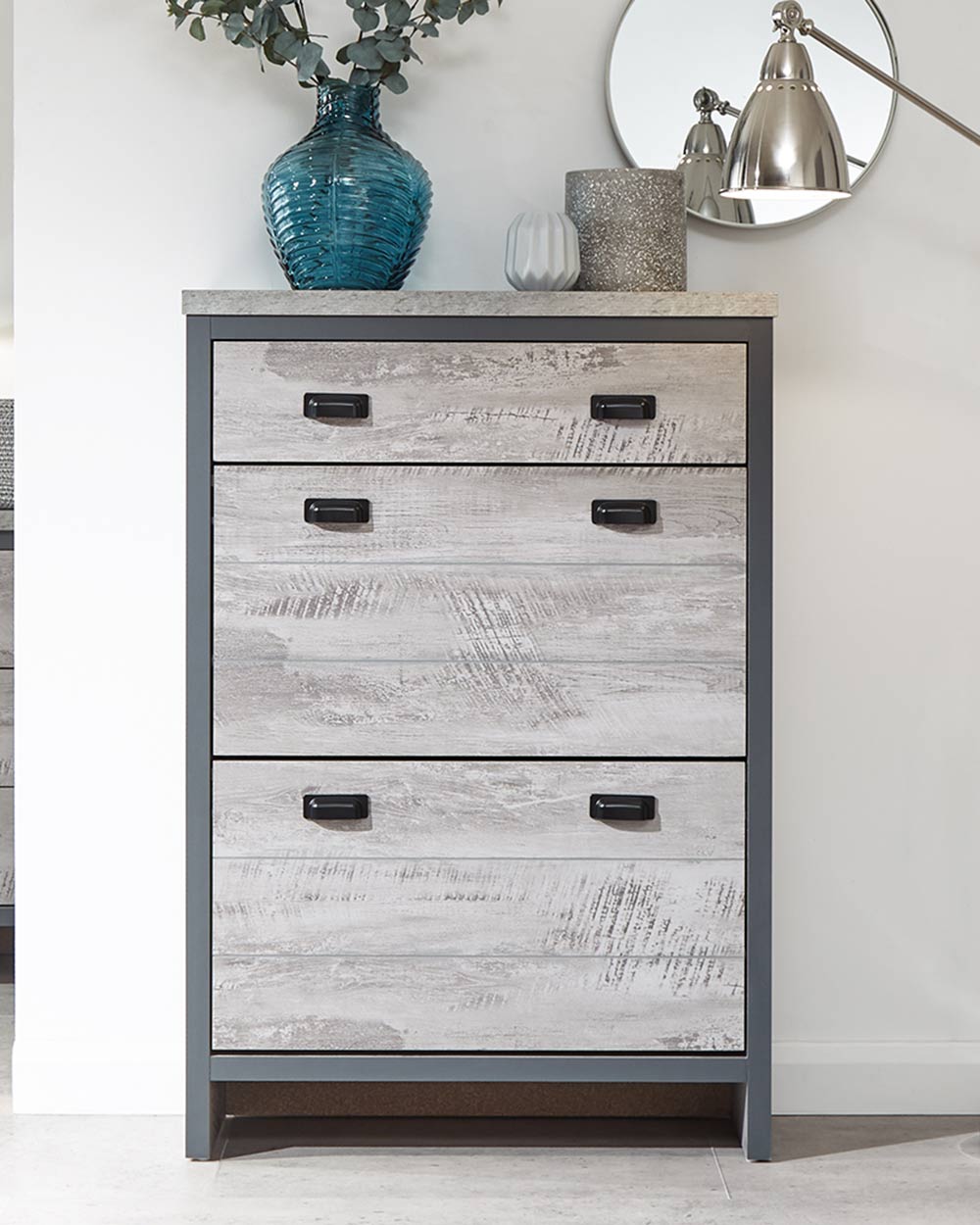 Looking for modern inspired shoe storage? This slim shoe cabinet will create the tidiest of bedrooms, living rooms, or hallways!  It's slender design makes it a smart choice for narrow spaces.