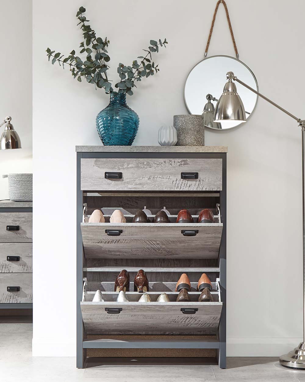 Looking for modern inspired shoe storage? This slim shoe cabinet will create the tidiest of bedrooms, living rooms, or hallways!  It's slender design makes it a smart choice for narrow spaces.