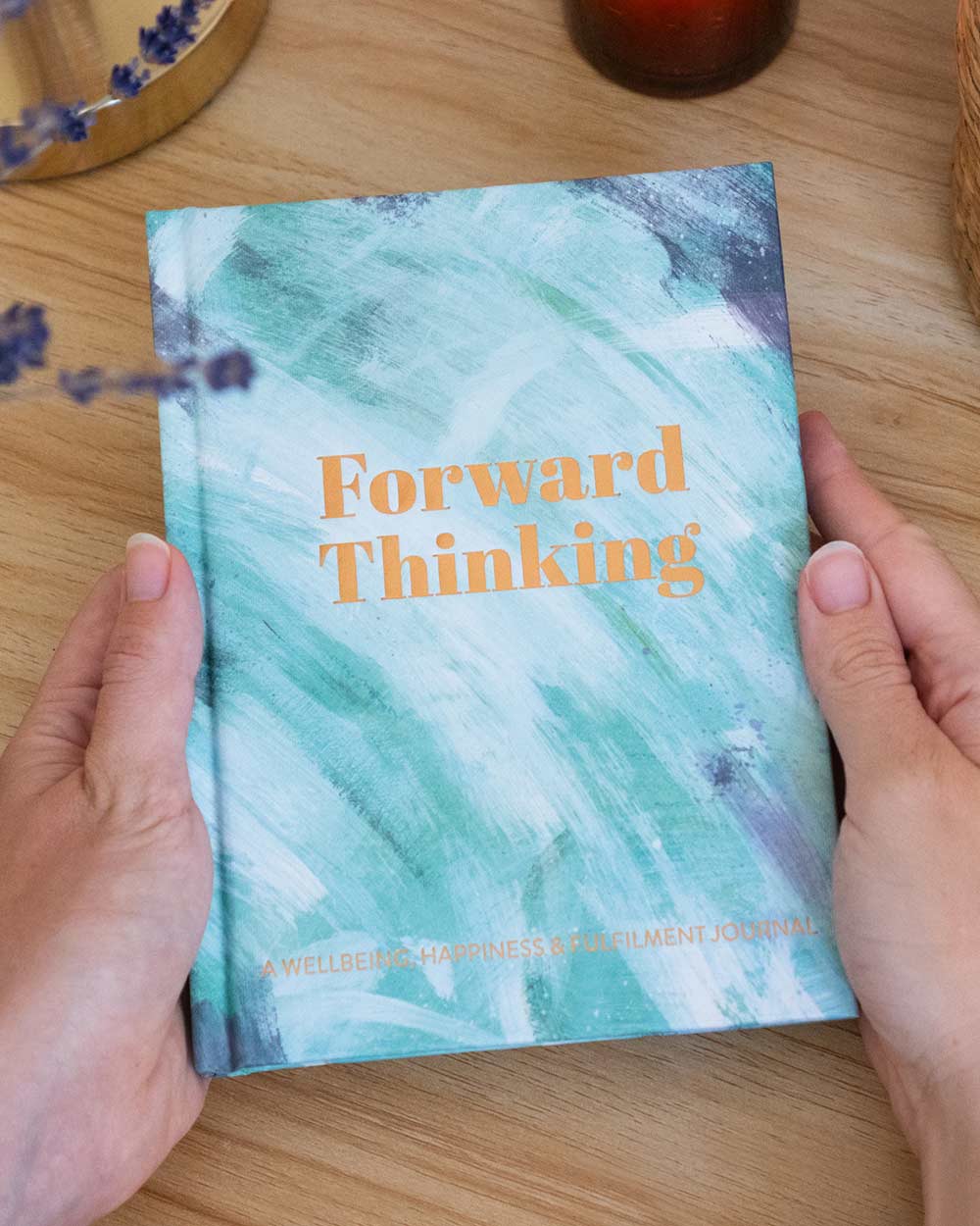 Mental health journal forward thinking positivity diary memory wellbeing happiness. Image of a lady holding the diary