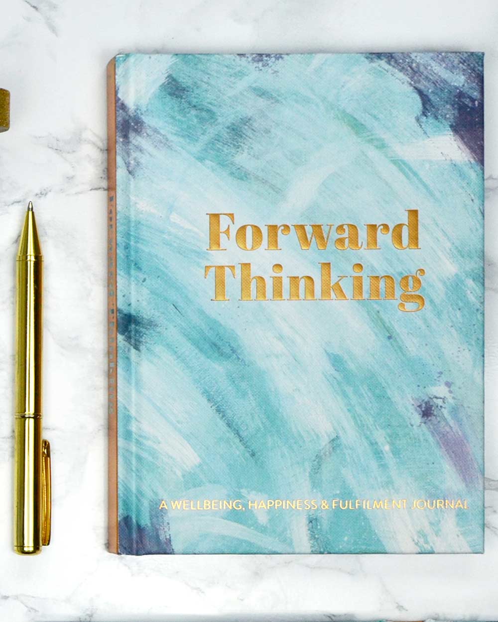 Mental health journal forward thinking positivity diary memory wellbeing happiness. Image the diary with a pen photographed on a marble background