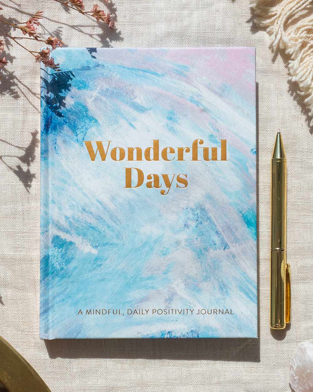 wonderful days journal, diary positivity mental health awareness. Photo of the journal on a tablecloth with a pen