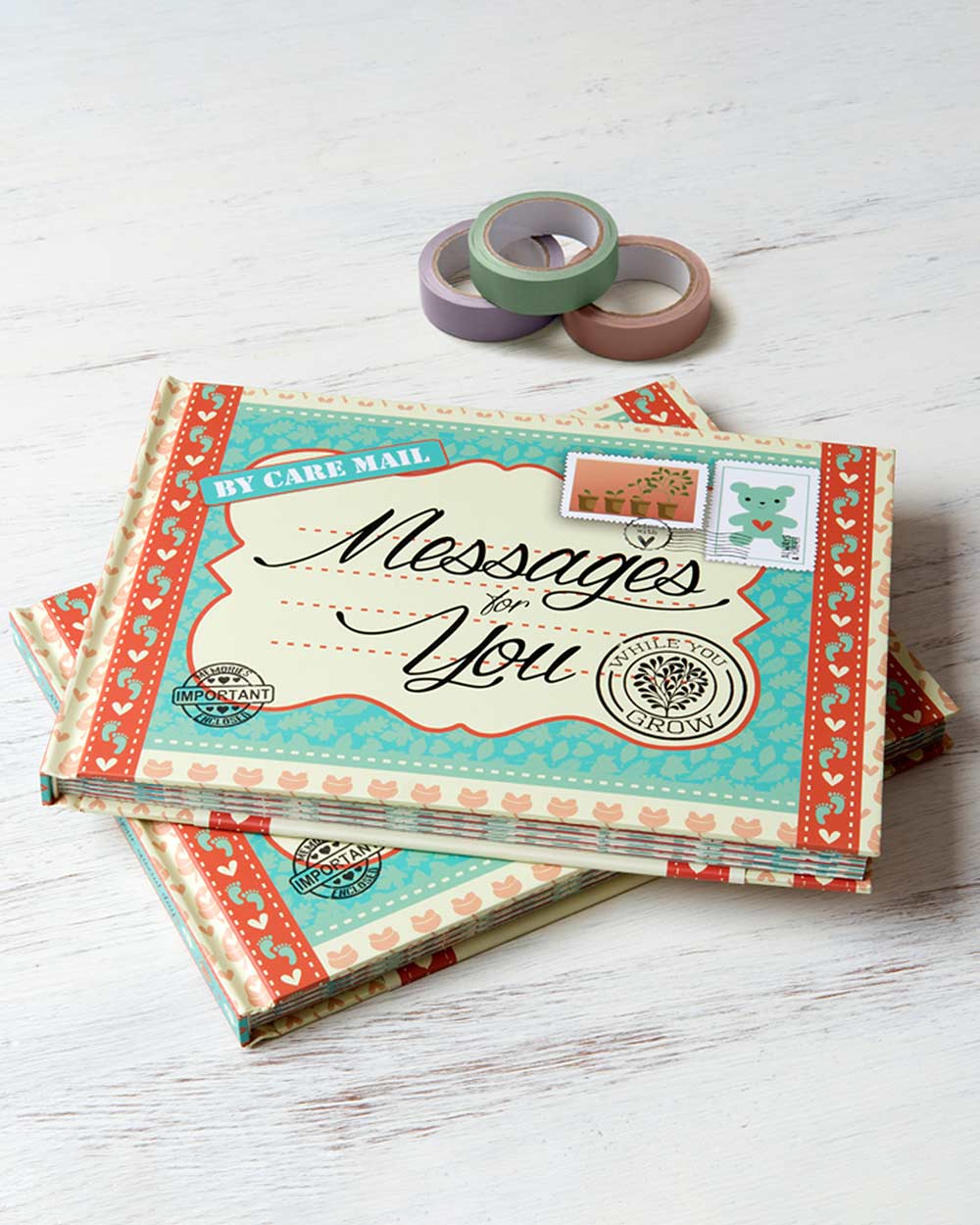 keepsake baby book, messages for while you grow. Lifestyle photo of the front cover of the book displayed on wooden table