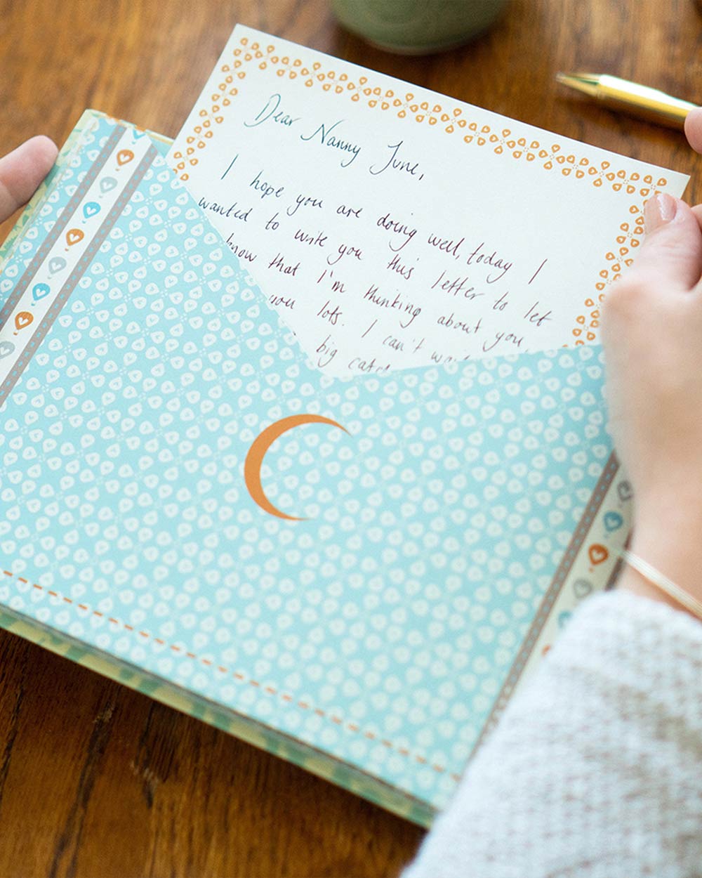 Keepsake Book Messages For You, While You’re Away. Lifestyle image of someone putting the message inside the book
