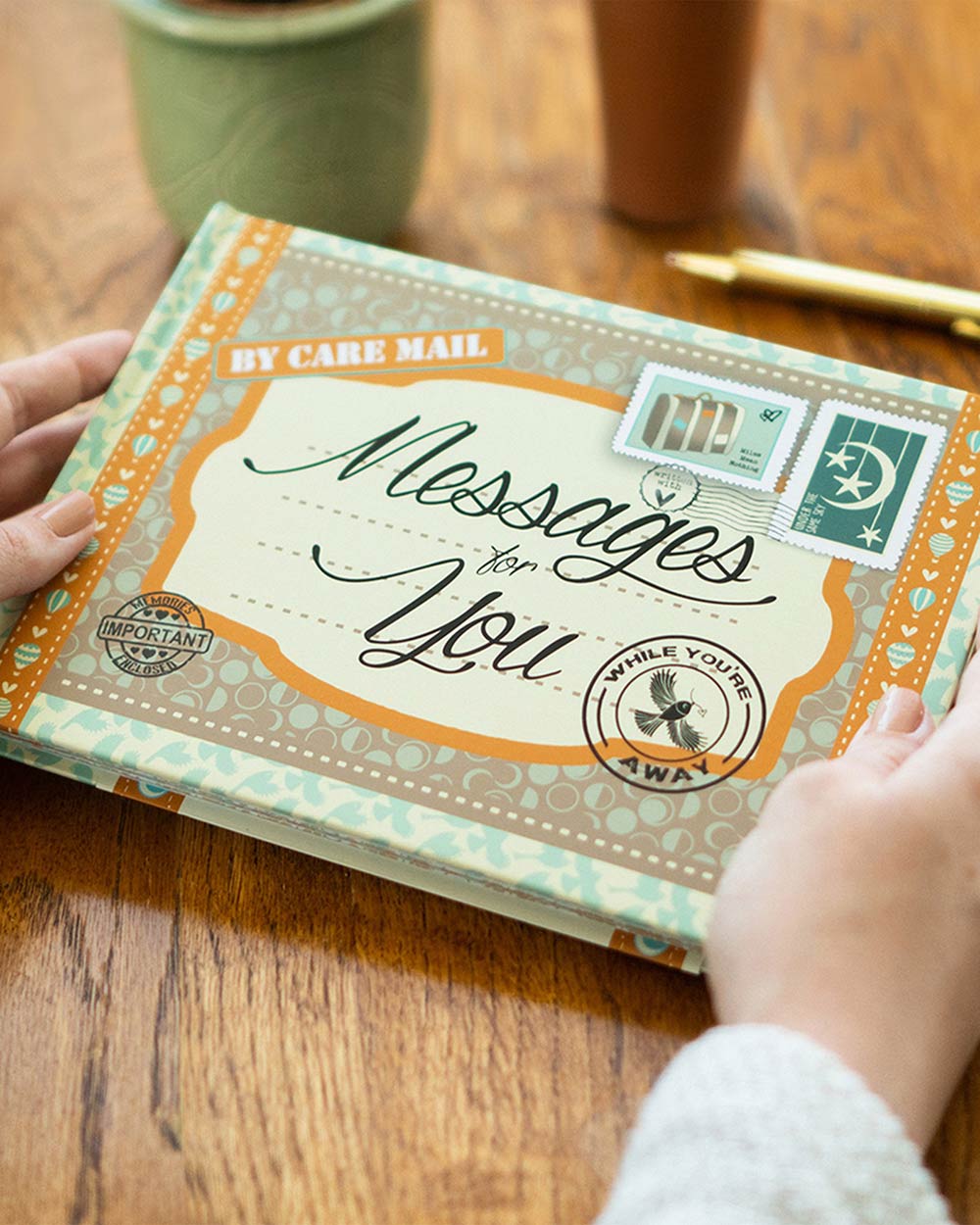 Keepsake Book Messages For You, While You’re Away. Lifestyle image of someone holding the book