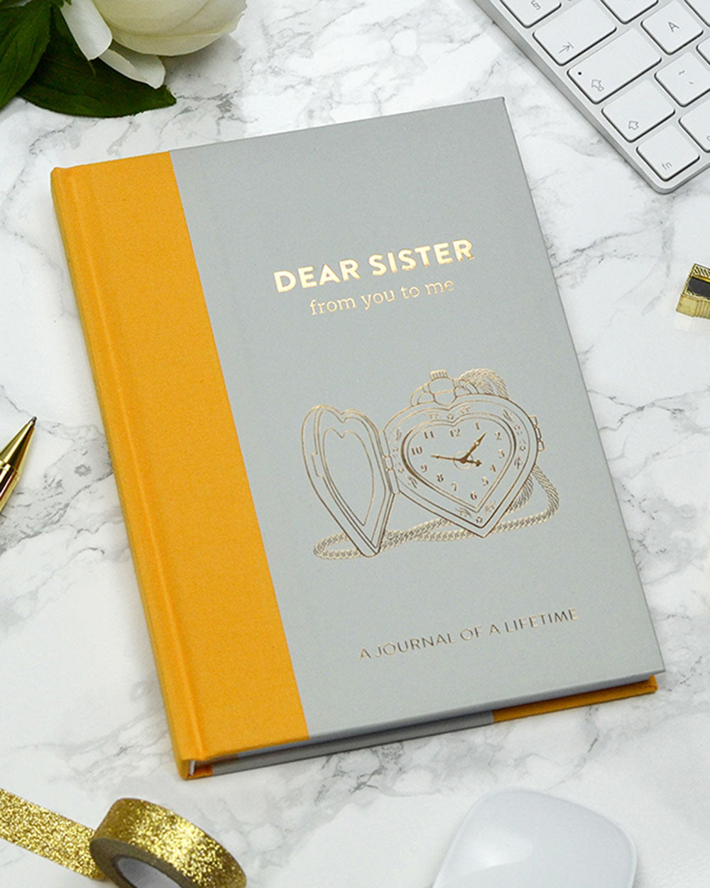 Memory Book Dear Sister From You To Me Journal Timeless. Lifestyle image of the book laying flat on a marble table