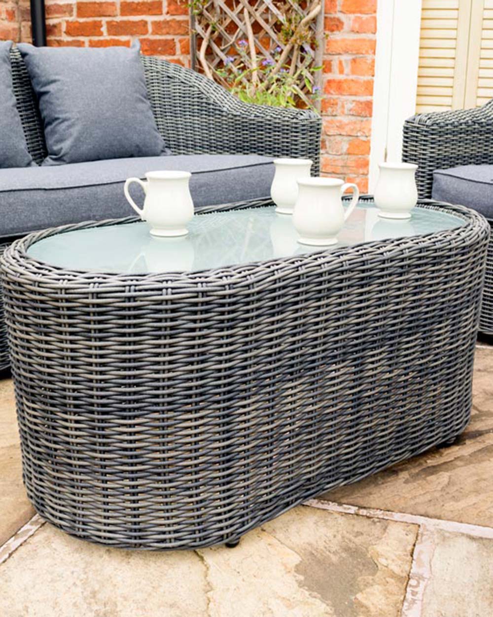 close up of the rattan furniture set displayed on a patio of the coffee table