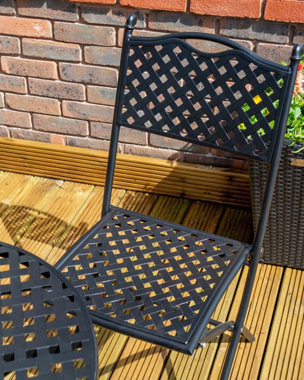 garden bistro set black matt lattice pattern Havana Rowlinson. Photo in a garden setting, close up of the black lattice and one of the chairs
