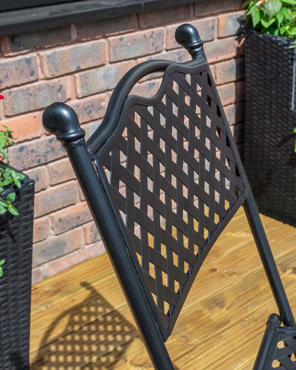garden bistro set black matt lattice pattern Havana Rowlinson. Photo in a garden setting, close up of the black lattice and one of the chairs back
