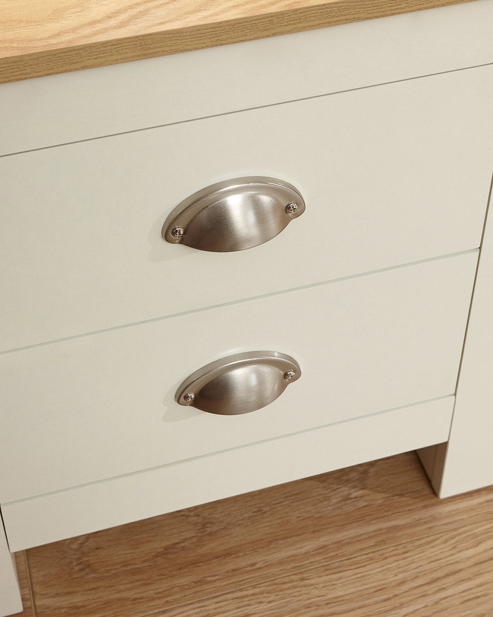 Lancaster bedside cabinet in cream with an oak effect top in a bedroom lifestyle setting close up of the drawer handles and finish