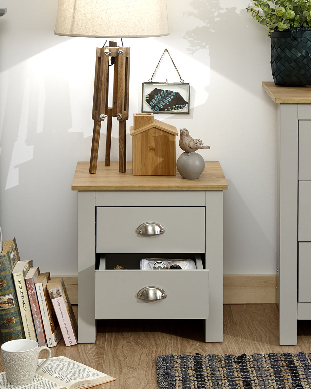 Lancaster 2 drawer bedside table cabinet in a lifestyle scene in a bedroom with the bottom drawer open