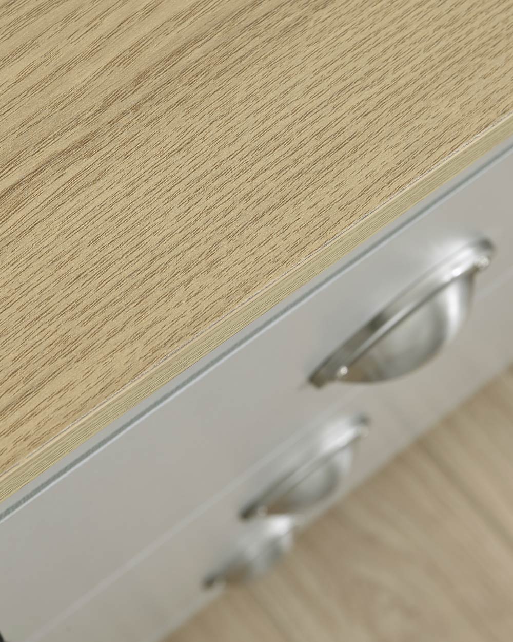 Lancaster 2 + 2 chest of drawers in grey in a lifestyle scene close up of the oak effect top