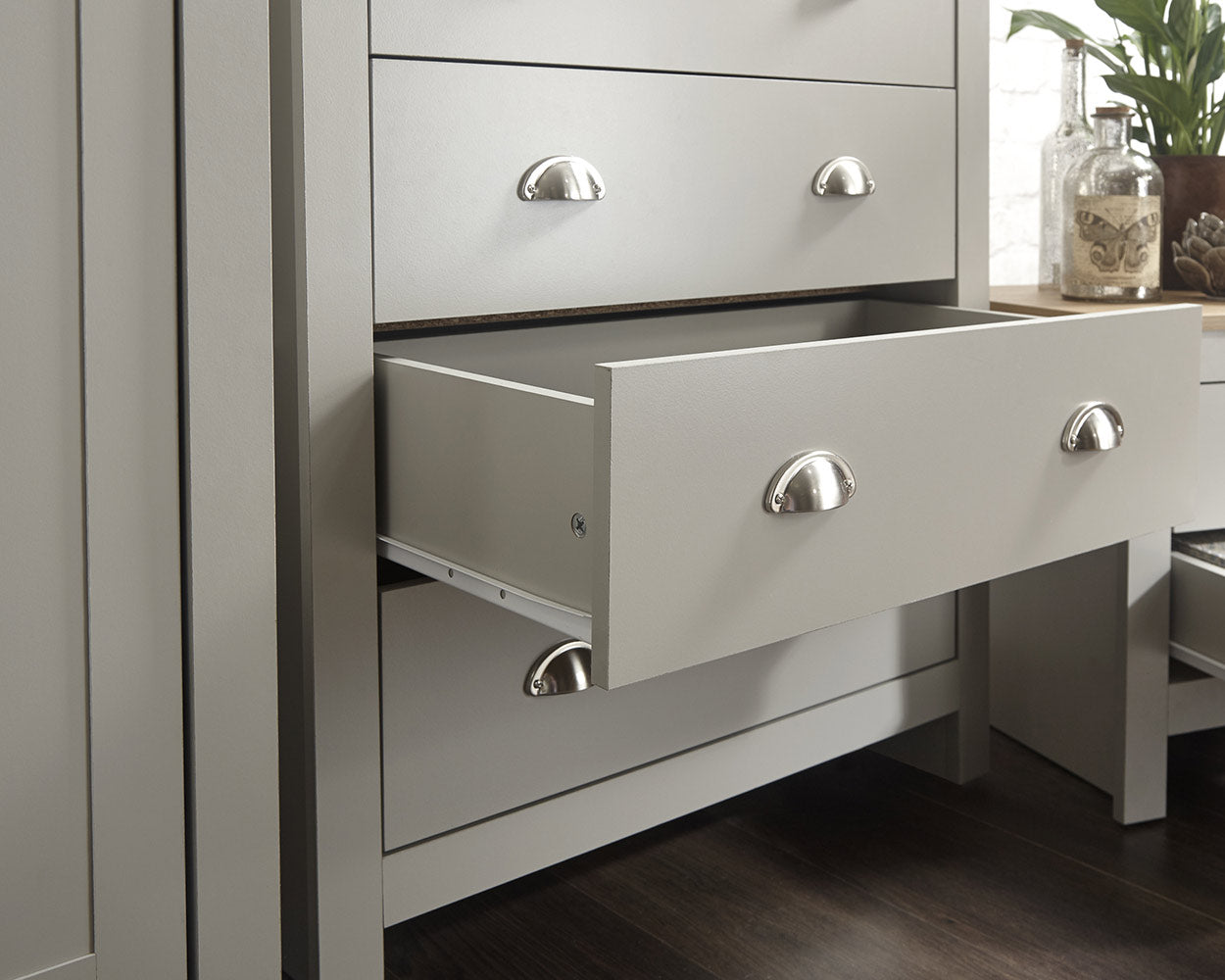 Lancaster 3 Piece Bedroom Furniture Set Grey lifestyle image in a bedroom of the chest of drawers close up with one drawer pulled open