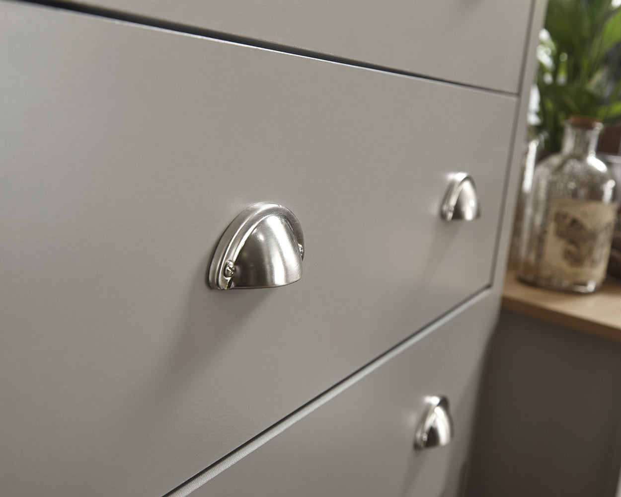 Lancaster 3 Piece Bedroom Furniture Set Grey lifestyle image in a bedroom. Close up of the brushed silver handles