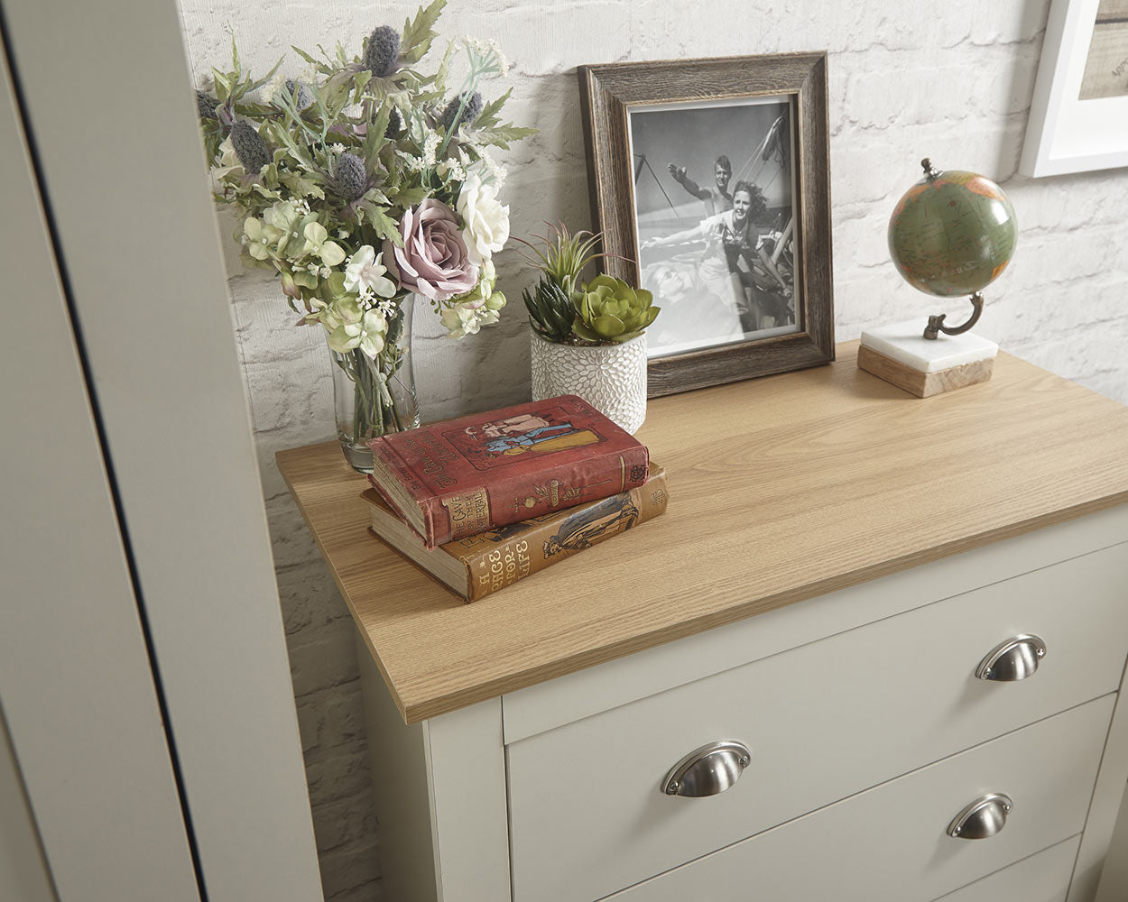 lancaster 3 piece bedroom set in cream with oak effect tops close up of the oak effect on the set of drawers in a lifestyle setting