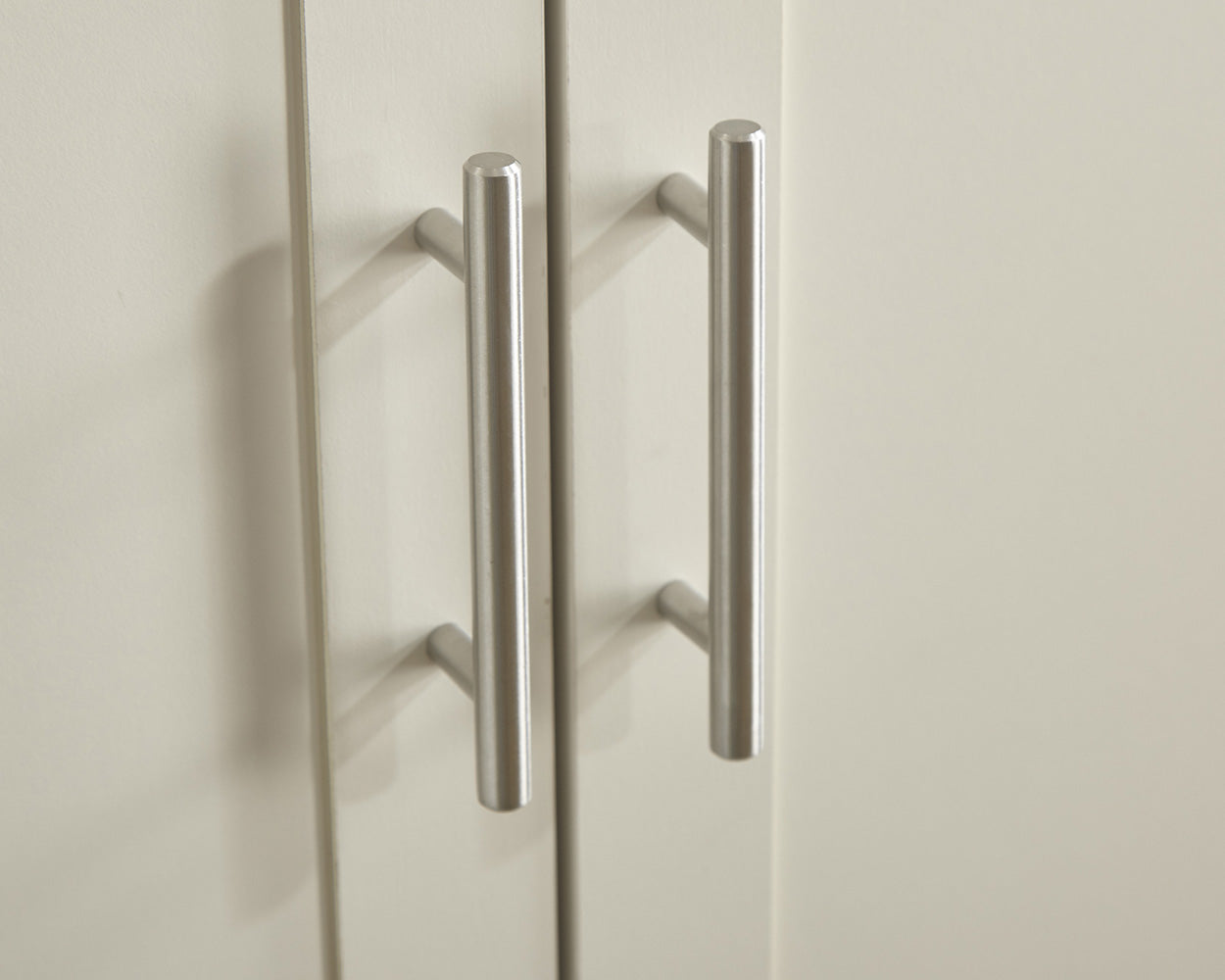 lancaster 3 piece bedroom set in cream with oak effect tops close up of the wardrobe handles in a lifestyle setting