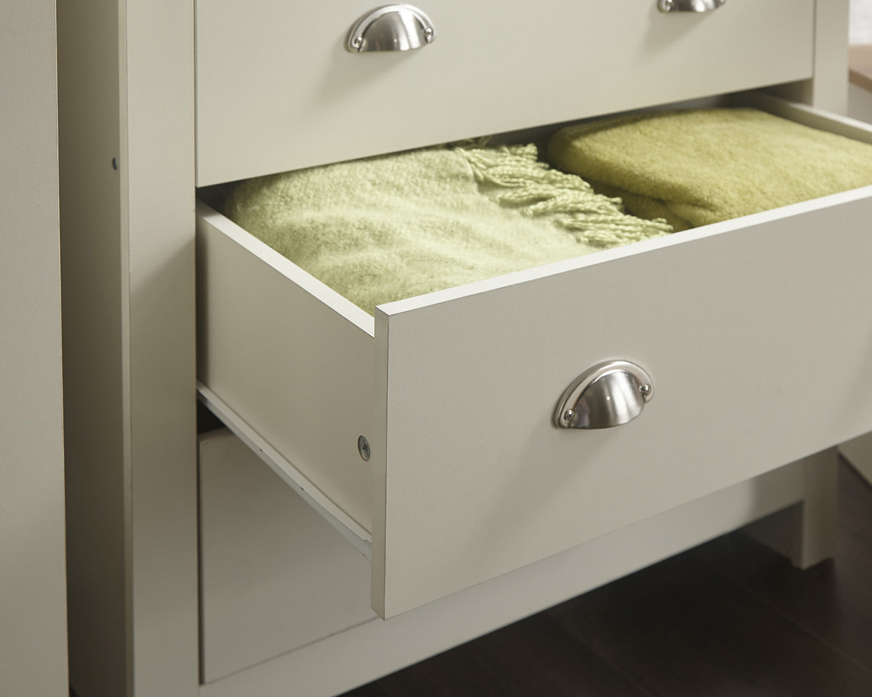 lancaster 3 piece bedroom set in cream with oak effect tops close up of the chest of drawer handles in a lifestyle setting
