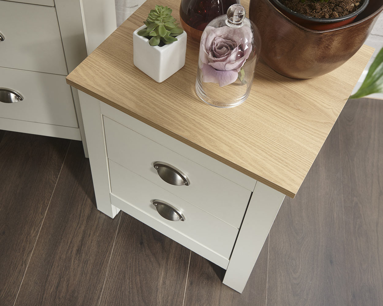 lancaster 3 piece bedroom set in cream with oak effect tops close up of the bedside table in a lifestyle setting top view