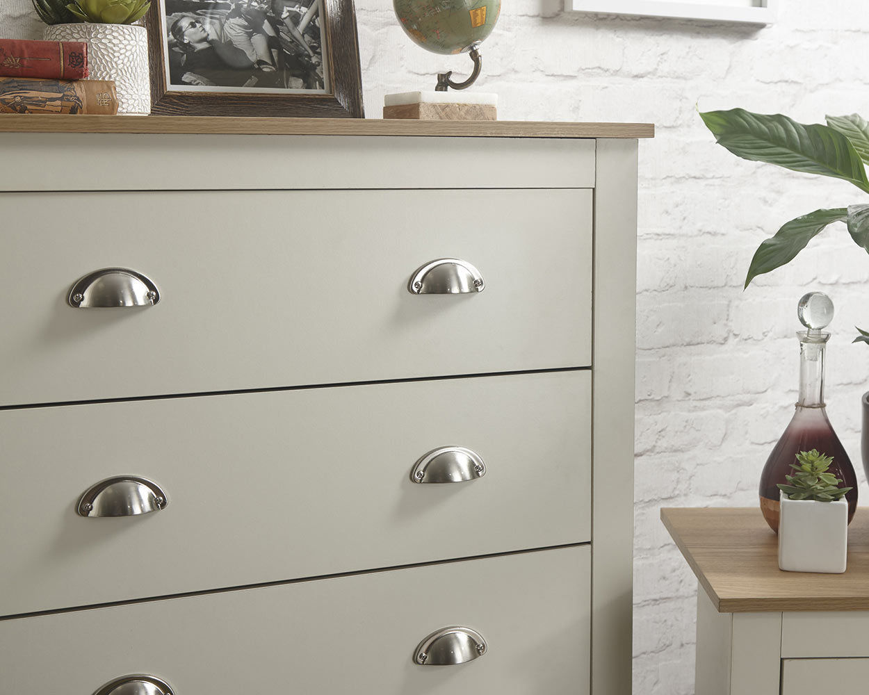 lancaster 3 piece bedroom set in cream with oak effect tops close up of the chest of drawers in a lifestyle setting