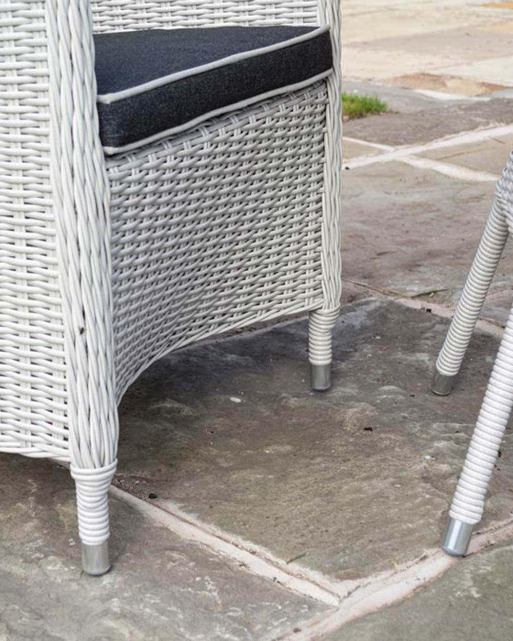 Close up of the aluminium legs and the rattan finish of the chair and table legs