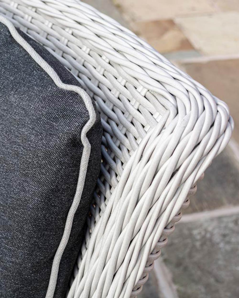 close up of the finish of the rattan weave on the light grey chairs