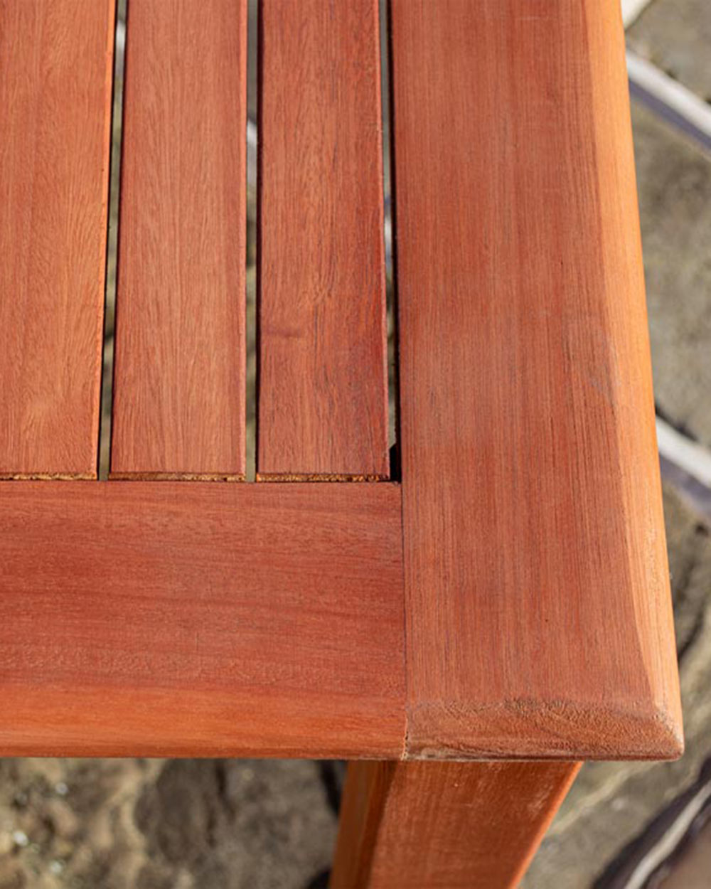 Close up of the garden furniture's wooden table rounded corners