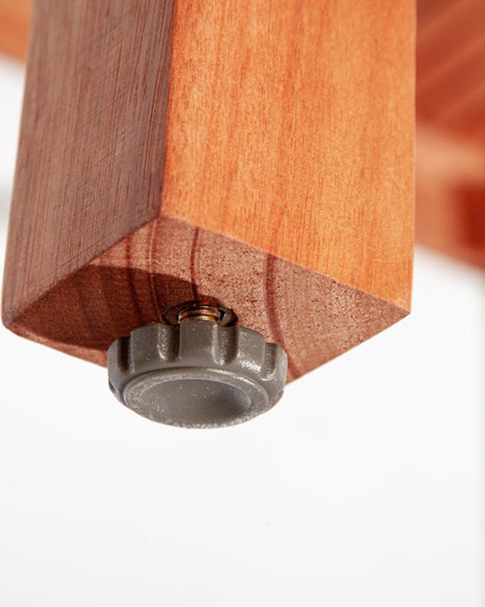 close up of the levelling feet on the wooden table