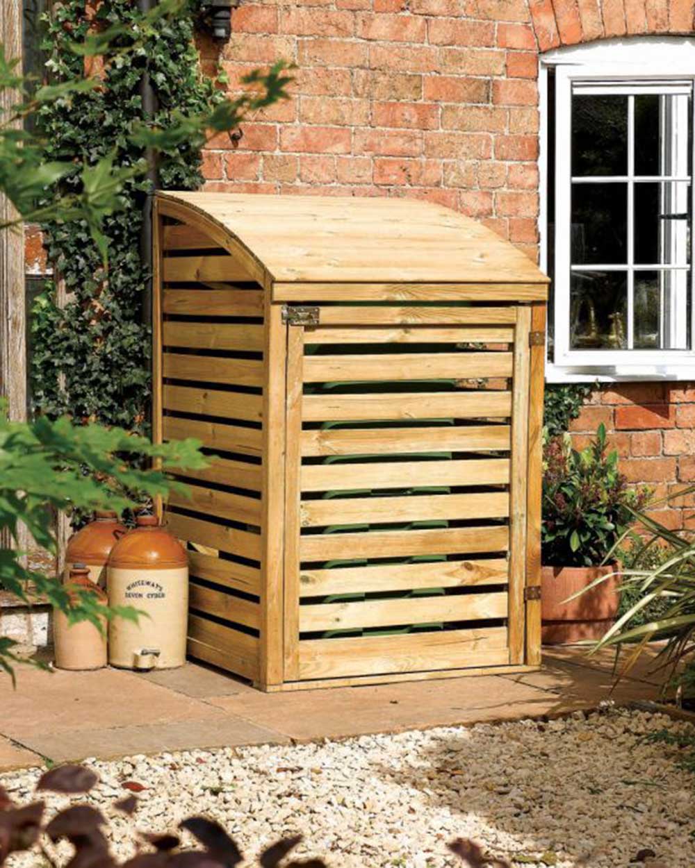 single wheelie bin storage shed with a curved lift in a garden setting with bin inside and locked.