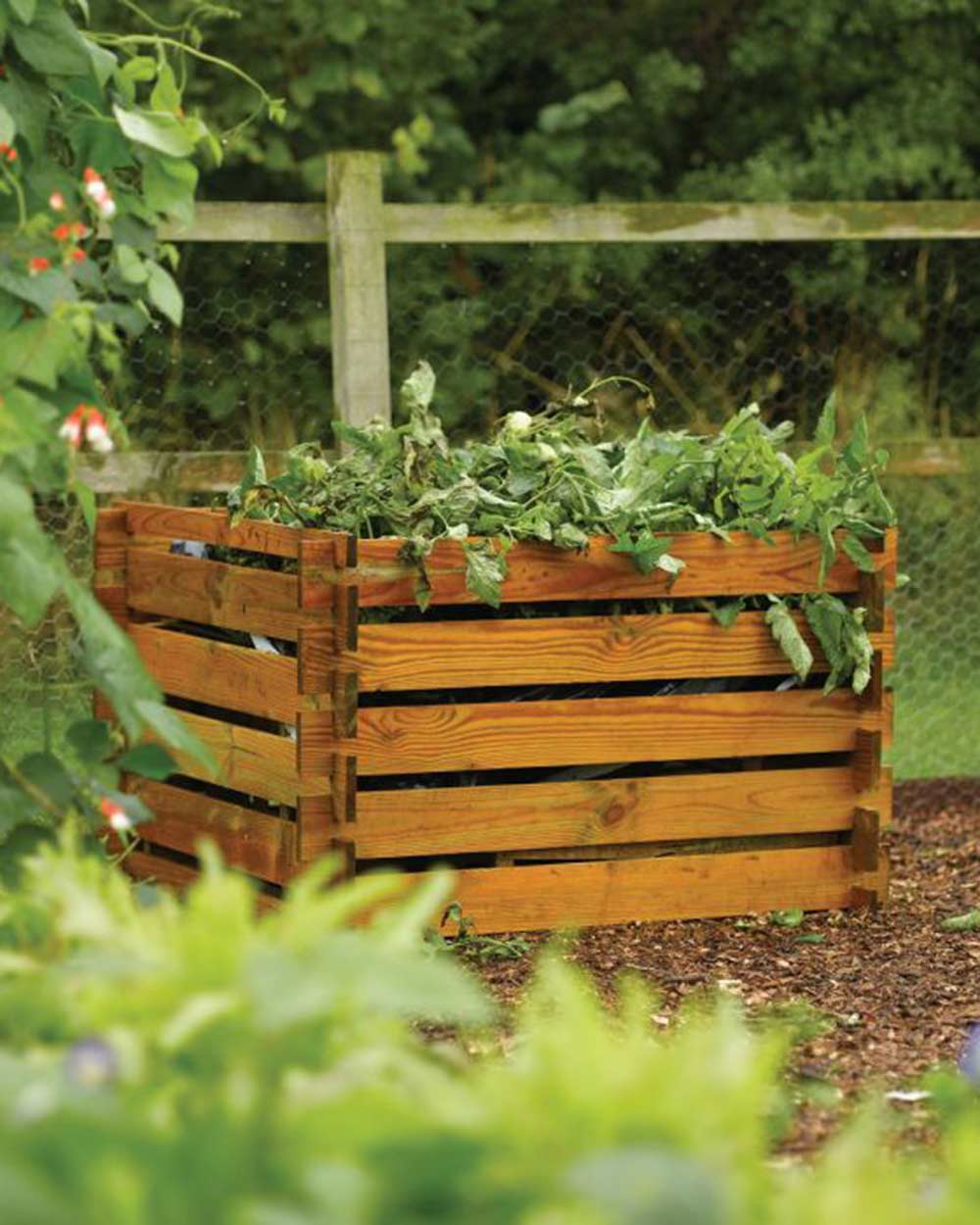 garden compost bin Rowlinson garden products budget composter. Picture of the composter in a garden and full with trimmings