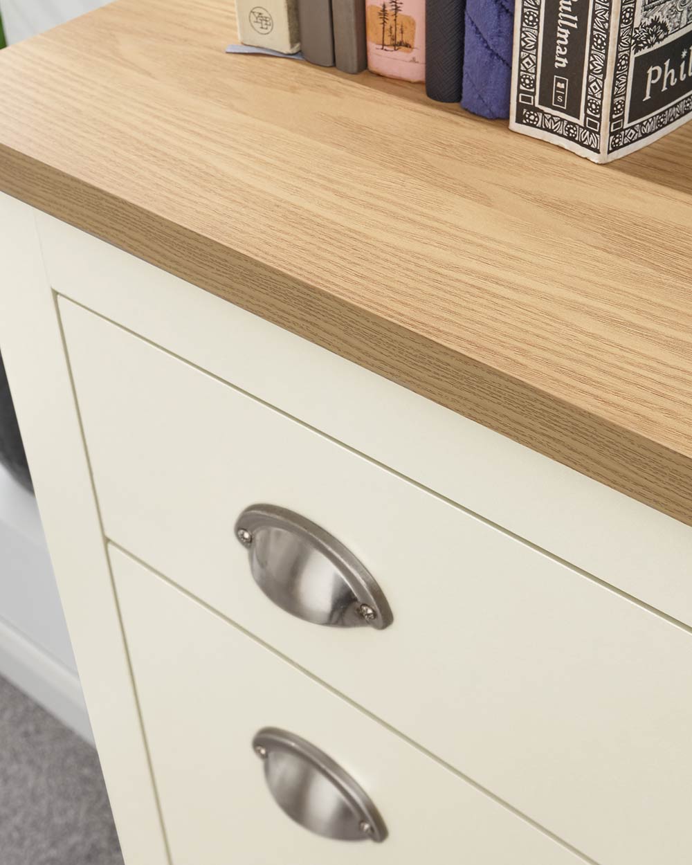 lancaster shoe storage cabinet in cream in a lifestyle setting close up of the oak veneer top and the handles