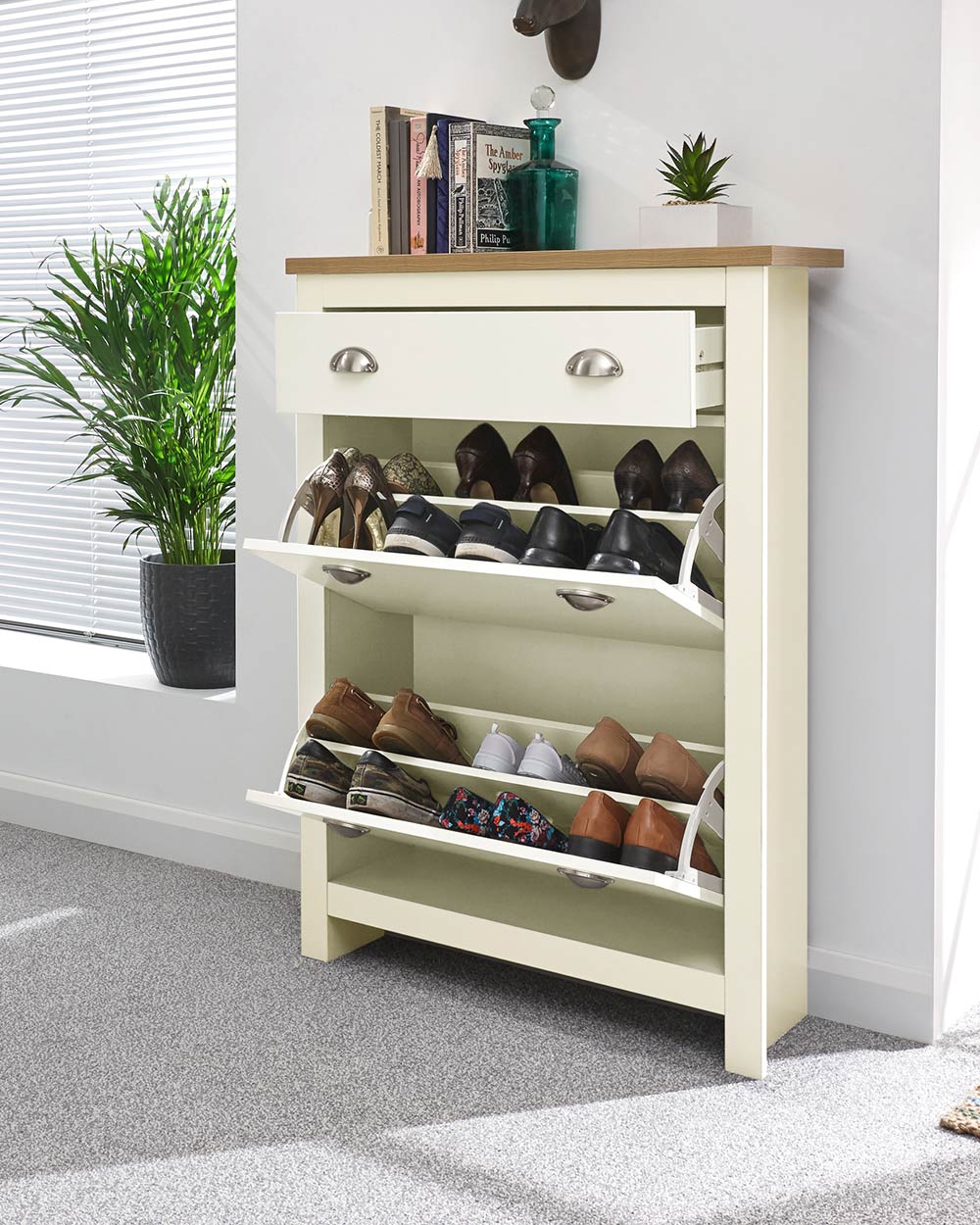 lancaster shoe storage cabinet in cream in a lifestyle setting with the drop doors down