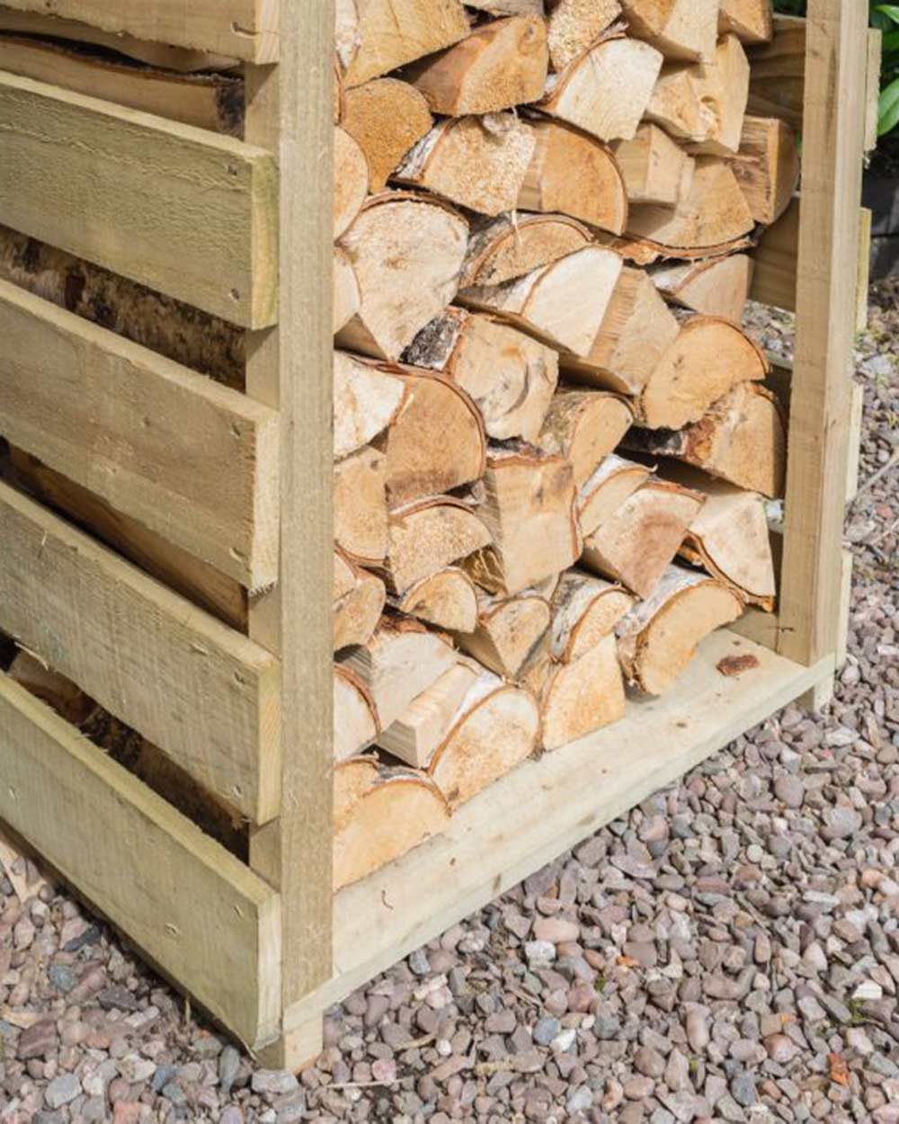 Slim log store narrow outdoor storage for wood kindling. Photographed in the garden with wood and kindling stored inside. Close up of the bottom