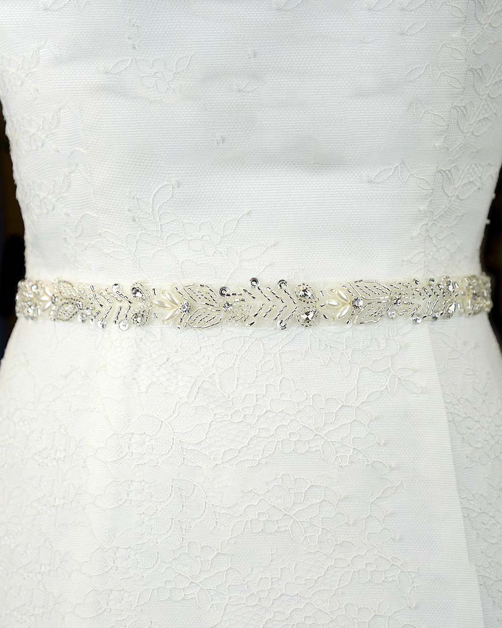 This beautiful wedding belt has a stunning leaf beaded design. With pearls and diamantes adding extra glamour to any wedding dress. Displayed on an 81" ivory organza ribbon, simply tie around your waist.