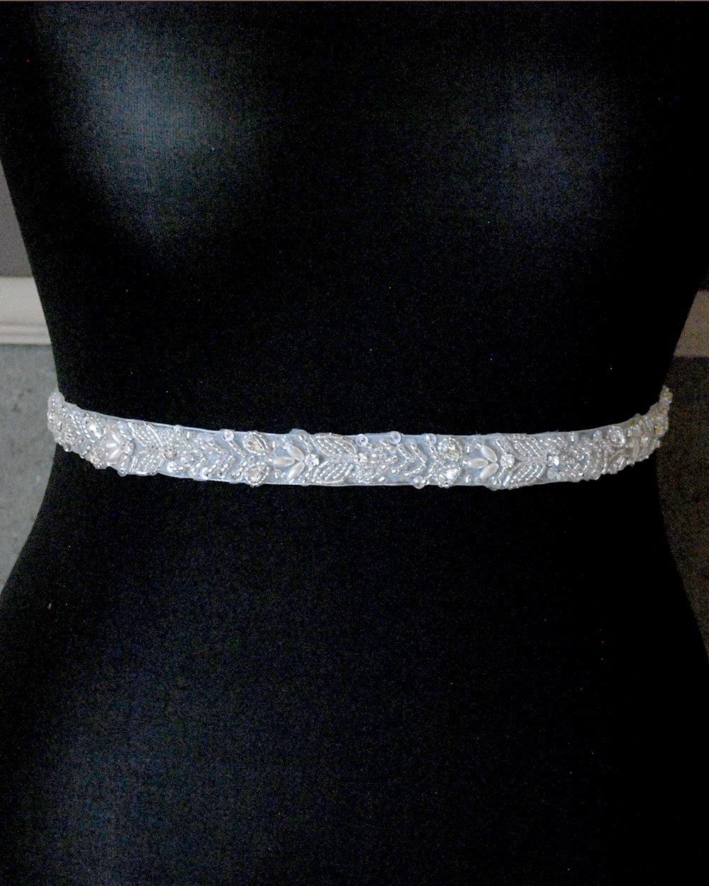 This beautiful wedding belt has a stunning leaf beaded design. With pearls and diamantes adding extra glamour to any wedding dress. Displayed on an 81" ivory organza ribbon, simply tie around your waist.