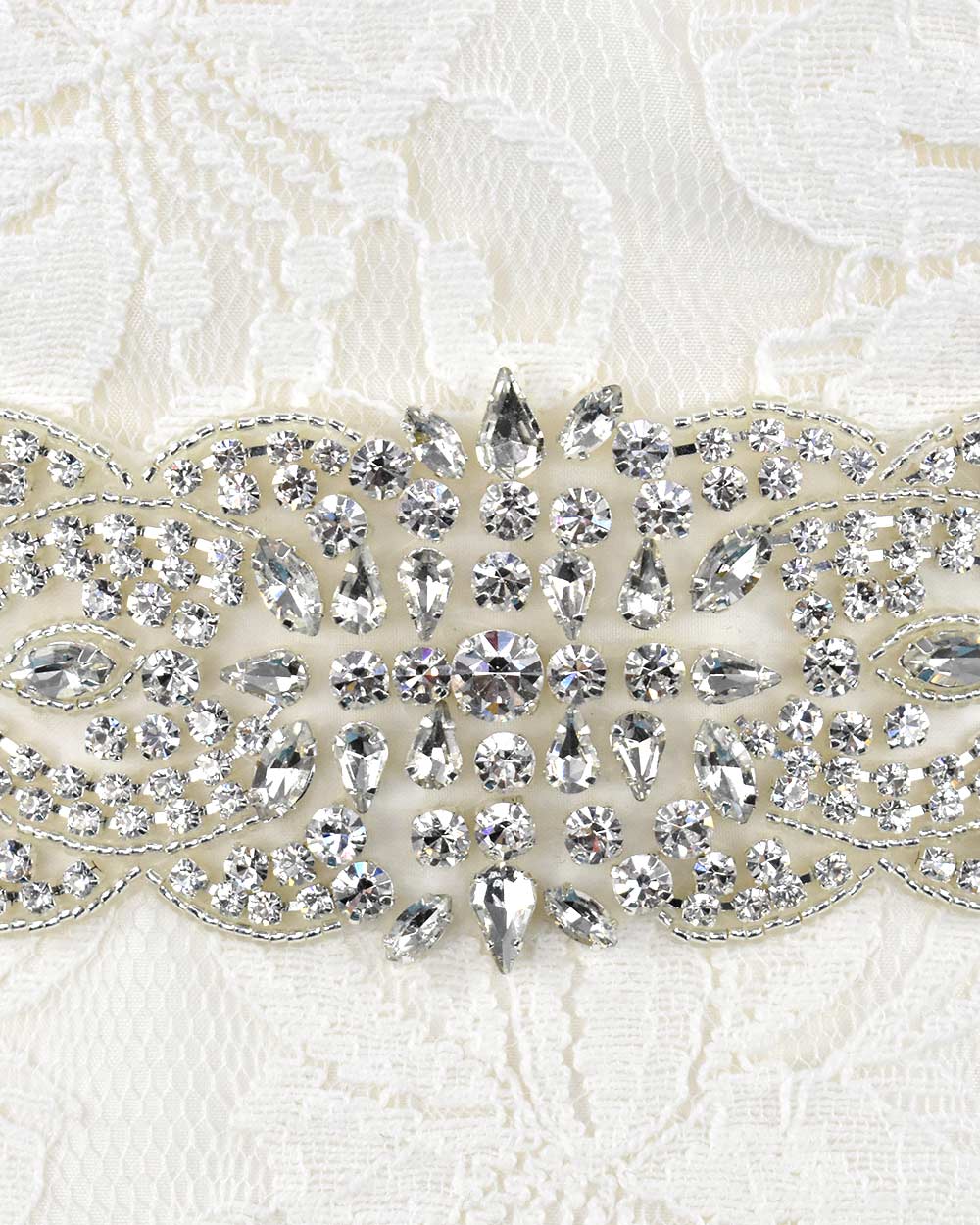 This wedding belt is bound to make a statement and give the wow factor to your dress. This diamante wide belt is adorned with stunning rhinestone diamantes and beading detail. Displayed on an 66" organza ribbon to easily tie around your waist. Adding luscious sparkle to any wedding dress.