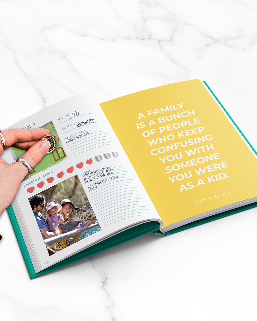 100 Things To Do With Family Scratch Book Activity book open on marble surface