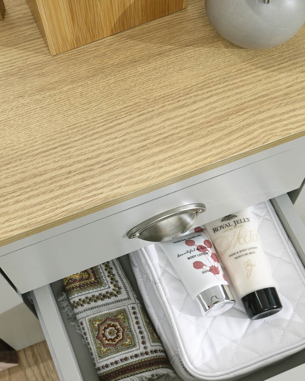 Lancaster 2 drawer bedside table cabinet in a lifestyle scene in a bedroom close up of the oak effect and drawer capacity
