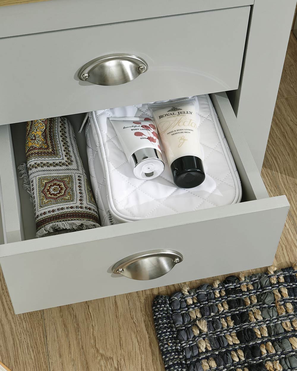 Lancaster 2 drawer bedside table cabinet in a lifestyle scene in a bedroom close up of the drawer with displayed items