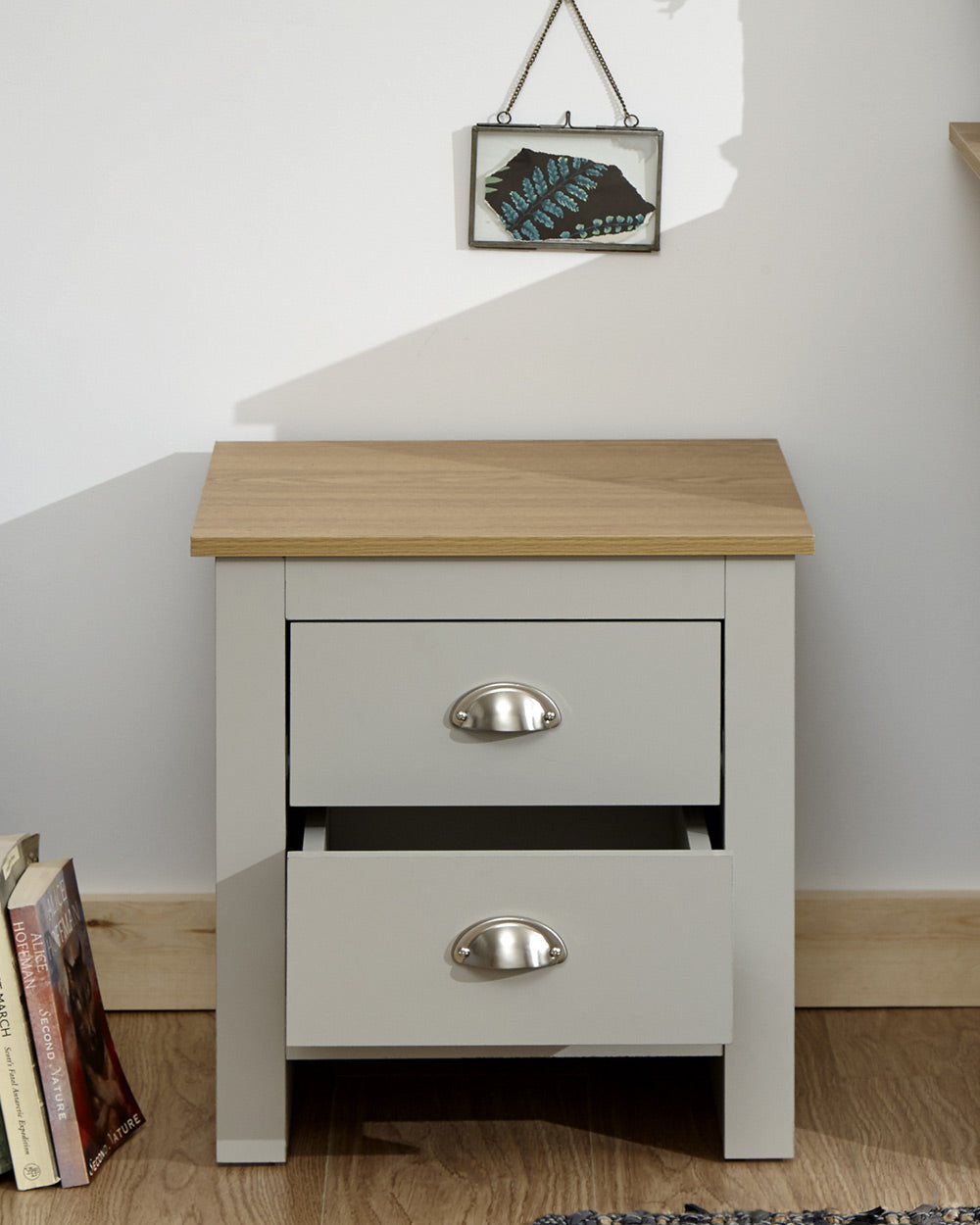 Lancaster 2 drawer bedside table cabinet in a lifestyle scene in a bedroom with the bottom drawer open