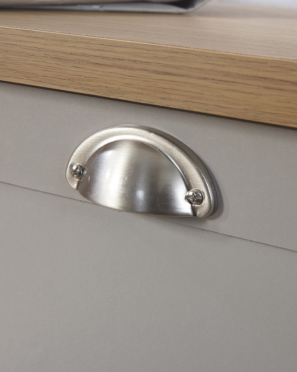 Lancaster shoe storage lifestyle inside a hallway setting. Grey with an oak effect top a close up of the brushed silver handles