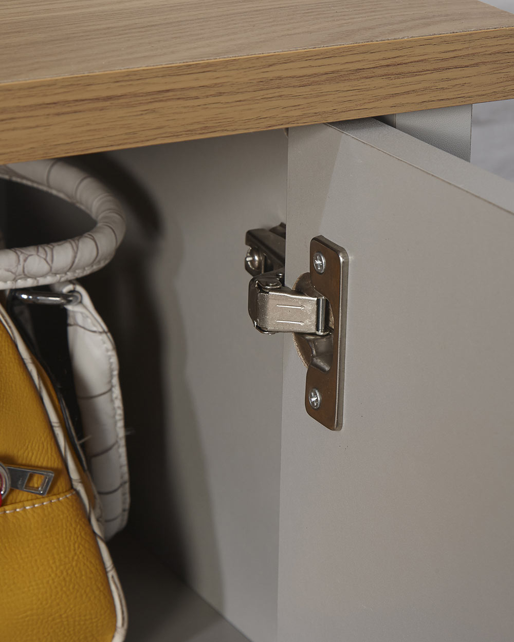 Lancaster shoe storage lifestyle inside a hallway setting. Grey with an oak effect top a close up of the door open, close up of the hinge