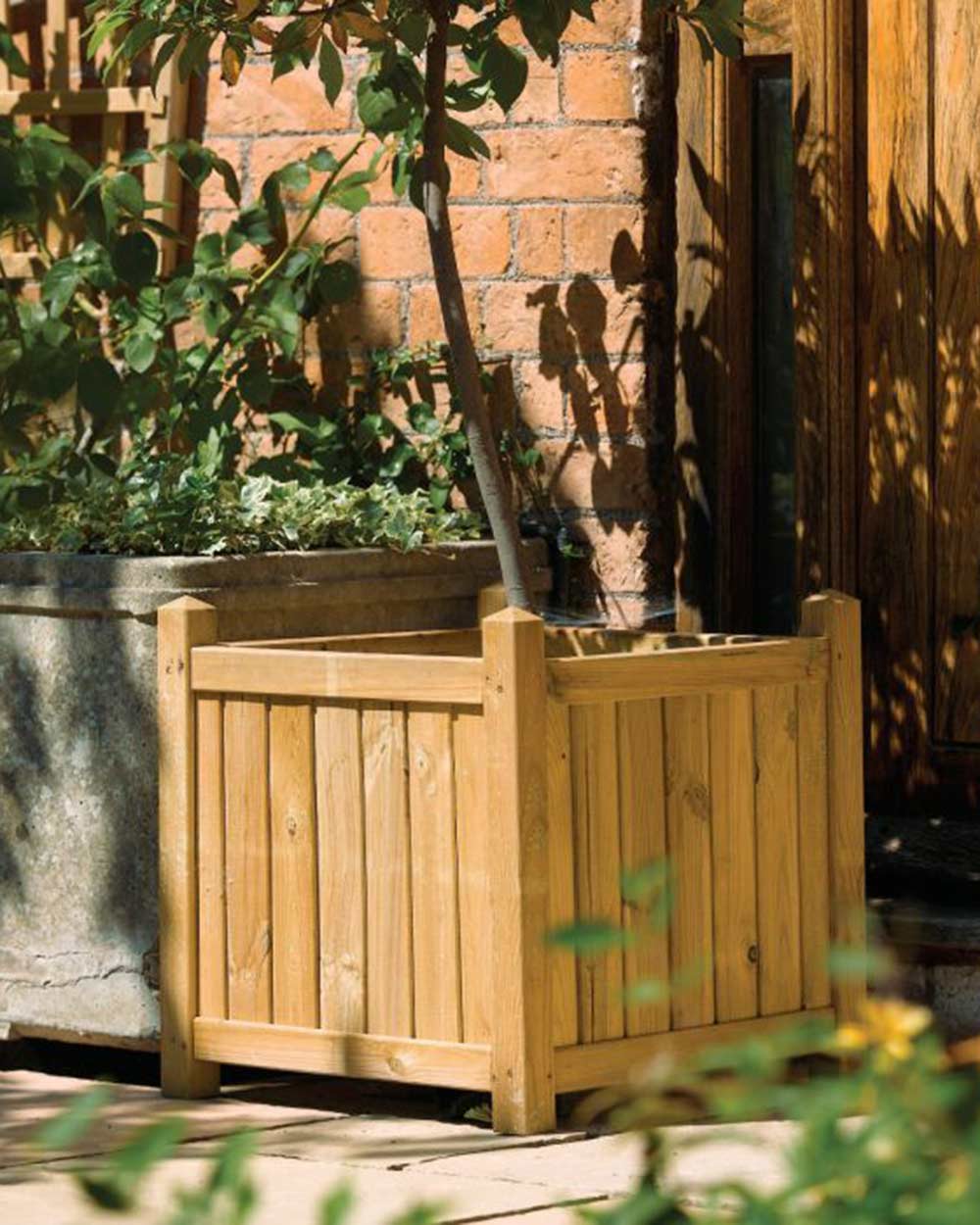 Square Wooden Garden Planter Rowlinson displayed in a garden